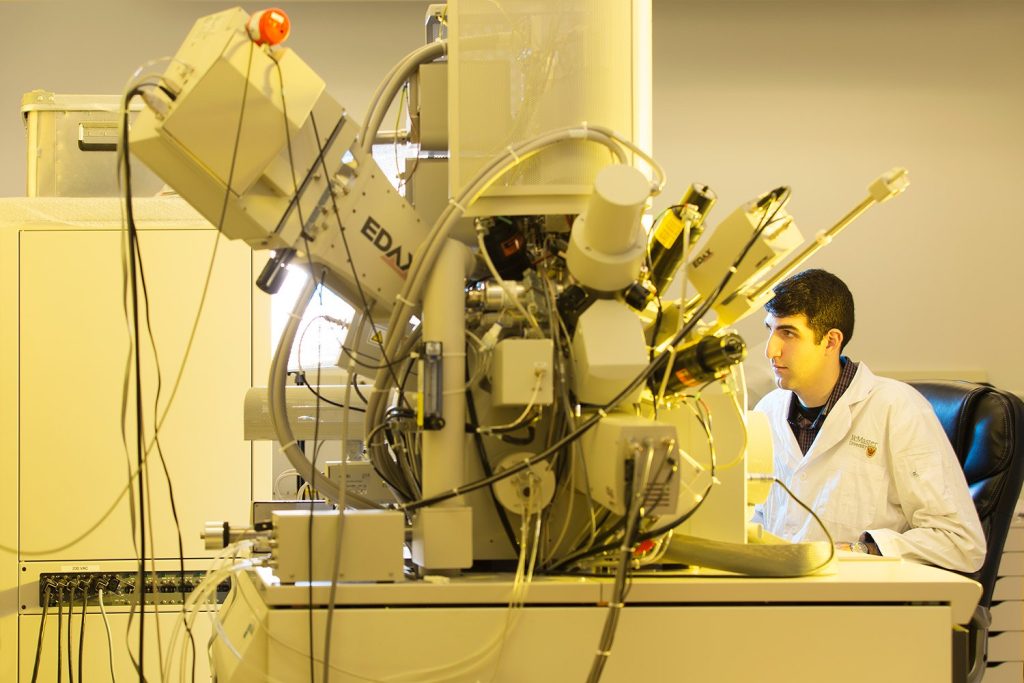 A student working on an electron microscope.
